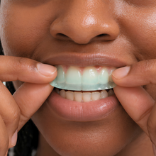 Mouth OS toothpaste film being placed on the front of the teeth before brushing